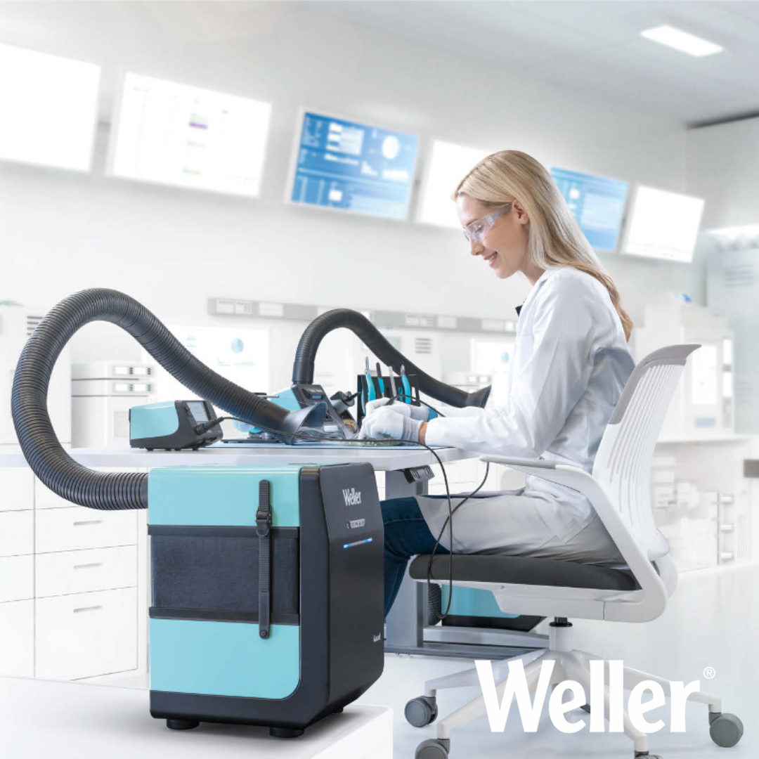 Tekniker udfører præcisionslodning på et printkort med en Weller loddekolbe, mens Wellers ZeroSmog Guard udsugningssystem effektivt fjerner lodderøg og partikler direkte ved arbejdsstationen.